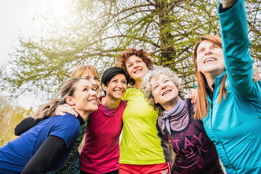 Group of vibrant women enjoying a day at the park. Casual bonding moment captured as friends share a joyful selfie, reflecting an active, multigenerational lifestyle 