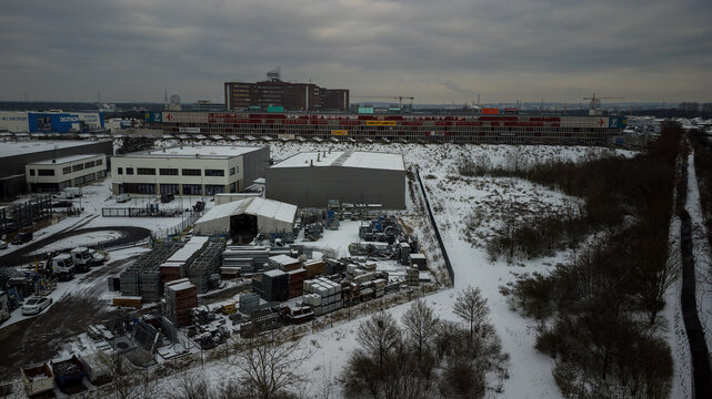 Weiterstadt, Germany January 19, 2024: View over the commercial area of Weiterstadt to the Loop shopping center with the highway in winter with snow