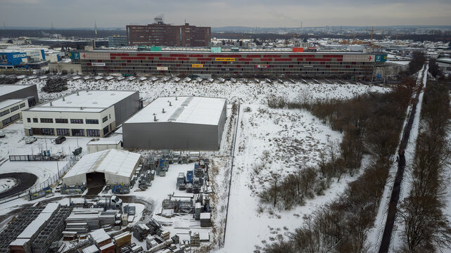 Weiterstadt, Germany January 19, 2024: View over the commercial area of Weiterstadt to the Loop shopping center with the highway in winter with snow