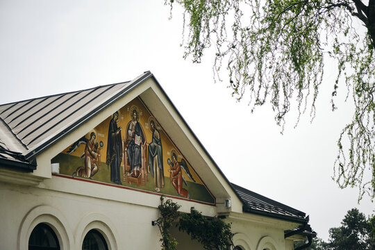Public place for believers to pray. Small town Bijeljina in Bosnia and Herzegovina country. The facade of the church building with the image of the icon of saints and angels.