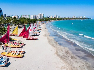 Aerial view of the city of Maceió and Pajuçara Beach with the rafts and the green sea