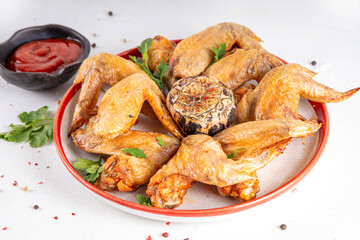 Grilled roasted spicy chicken wings with ketchup