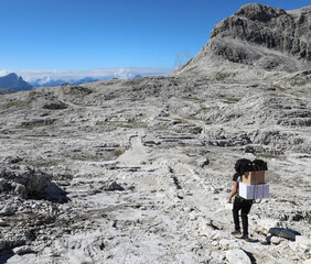 Mountaintop porter on the trail to deliver goods