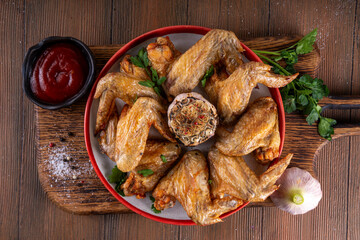 Grilled roasted spicy chicken wings with ketchup