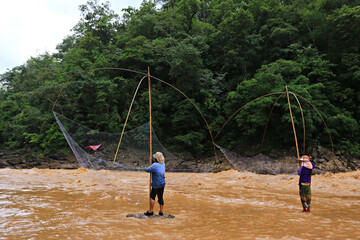 Fishermen using netting equipment (square dip net) in catching fish at Kaeng Luang, Nan Province, Thailand 
