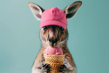 Fotobehang kangaroo eating ice cream, pink ice cream, kangaroo in cap, turquoise background, ice cream © Anastasia