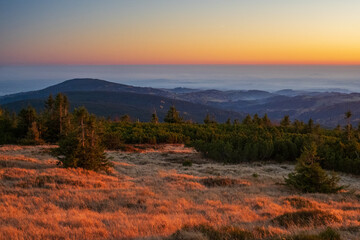 Sunset on the mountains during the inversion. Autumn landscape at sunset.