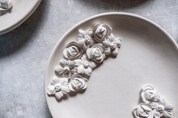 Decorative plate design with a realistic 3d embossed leaf design. Plaster stucco. Photo background.