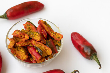 Red chilli pickle in transparent glass bowl - marinated with Fenugreek and mustard