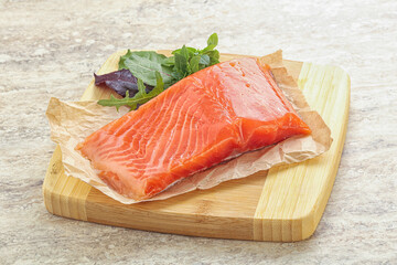 Raw salmon fillet over board