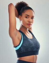 Fototapeta na wymiar Portrait, fitness and stretching with confident black woman in studio isolated on white background for workout. Exercise, health and warm up with serious young sports model at start of training