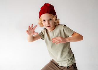 Young Boy Wearing Red Beanie Jumping in the Air