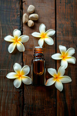 Obraz na płótnie Canvas frangipani essential oil in a bottle. Selective focus.
