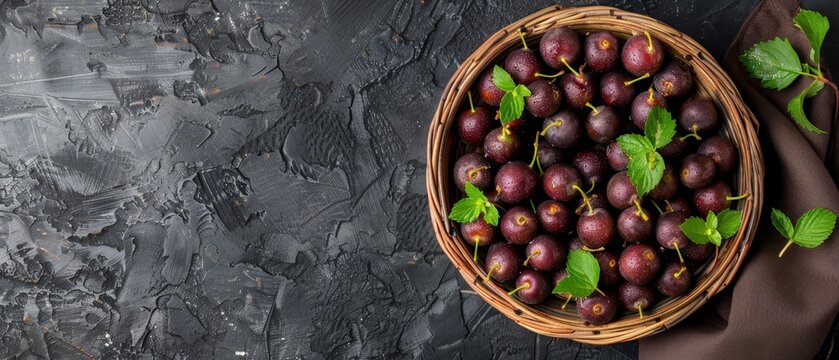   A tight shot of a plum basket on the table, accompanied by a napkin and a steaming cup of coffee