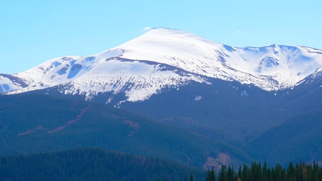 the top of the mountain is covered with snow
