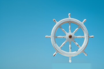 Close-up of a white wooden ship steering wheel isolated against a clear blue sky, symbolizing navigation and marine adventure.