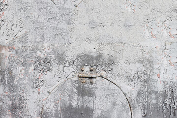 Metal wall with peeling gray paint.