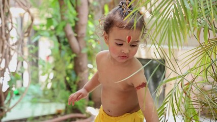 cute Indian boy with holy religious symbol on head at outdoor with from different angle at day