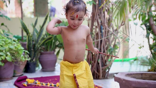cute Indian boy with holy religious symbol on head at outdoor with from different angle at day