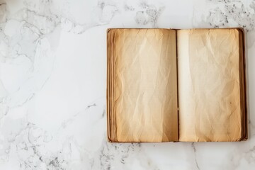 An old opened book with blank pages on a background of white gray marble. Top view. Layout of a book page template with space for text