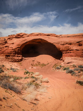 Red sandstone wind cave in sandy desert near Page Arizona