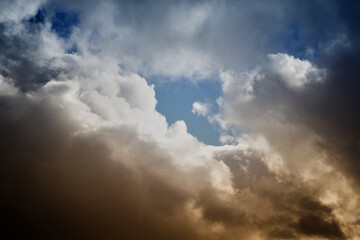 Cumulus clouds in unusual light in the sky, fantastic sky landscapes, unusual color of clouds in...