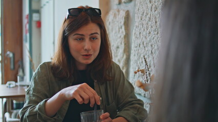 Carefree women communicating lunch break in cafe closeup. Stylish girl talking