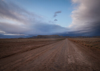 Fototapeta na wymiar Dirt road in Green River Utah desert at sunset
