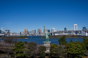 Tokyo seen from the artificial island of Odaiba in Tokyo Bay, linked by the Rainbow Bridge.