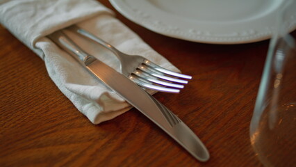 Elegant cutlery lying table cafeteria ready for use close up. Metal fork knife