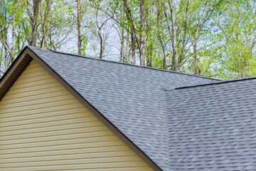 Newly built house roof top is covered with asphalt shingles © ungvar
