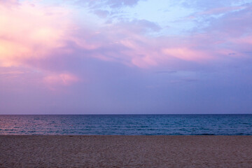 Mediterranean Sea and sandy beach at pinkish sunset. Sardinia.