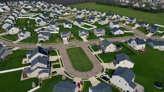 A slow forward aerial establishing shot view of a typical middle class Ohio residential neighborhood.  	