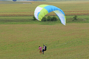 Paraglider flying from a hill	