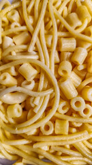 Background of various types of boiled mixed pasta