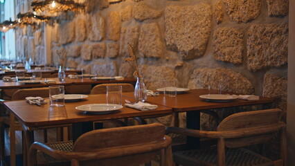Cozy cafe interior evening camera moving. Comfortable tables served tableware