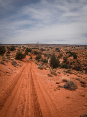 Red sandy dirt road in Page Arizona desert near Vermillion Cliffs