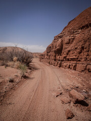 Vertical view of Red desert sand wash between dirt berms in Moab Utah