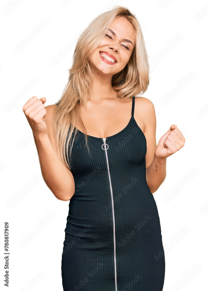 Poster young blonde girl wearing elegant and sexy look very happy and excited doing winner gesture with arm