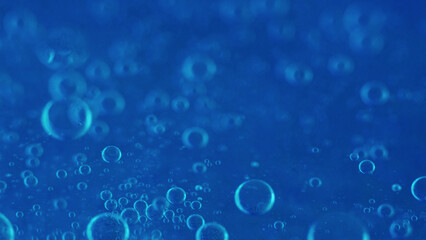 Air bubbles. Fizzy texture. Defocused blue color shiny gel water oxygen circles mineral hydrating...
