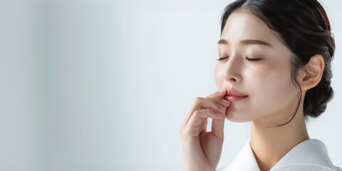 A woman enjoying her skincare routine with a serum, conveying a message of beauty and wellness