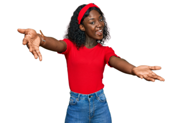 Beautiful african young woman wearing casual clothes smiling cheerful offering hands giving assistance and acceptance.