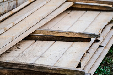 Fototapeta na wymiar Detail of wooden planks. Wooden pallets. Wood. Lumber. A stack of wooden planks in the lumber industry. Building material. Carpentry