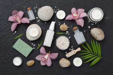 Composition with orchids, spa products on concrete background, top view