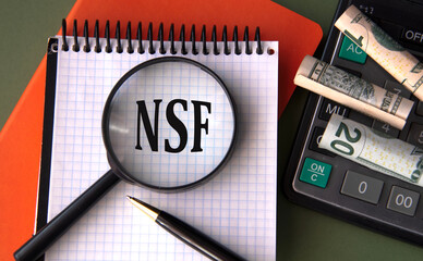 NSF - acronym under magnifying glass on the background of calculator and banknotes