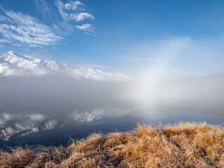 Sunrise on the mountain lake with fog.