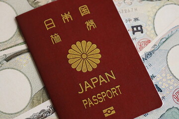Japan passport with japanese yen money bills on table close up. Tourism and travel concept