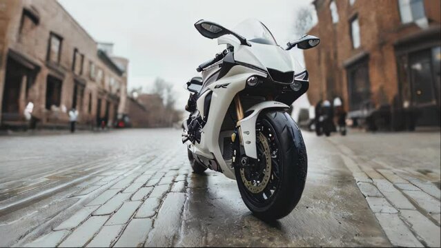 A white motorcycle is parked on a cobblestone street.