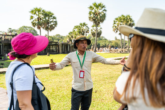 Tour guide explaining history at Angkor Wat temple