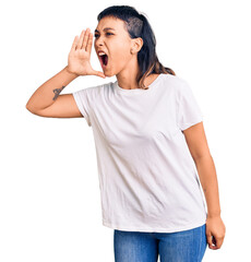 Young woman wearing casual clothes shouting and screaming loud to side with hand on mouth....